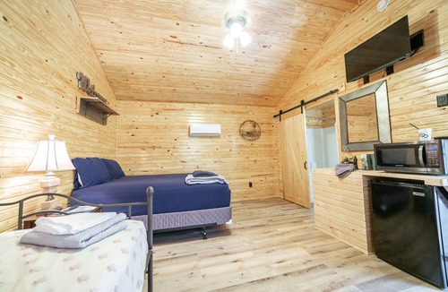 Ramer RV Rental | 1bd rm, 1 bth, hotel style cabin w/Mini fridge, micro, & tv, at Kick Back Ranch