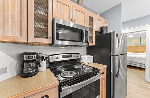 Baytowne Wharf Condo | 2BR Condo at Baytowne! Tram to Beach, Tropical Pool + Hot Tub, Walk-out Patio