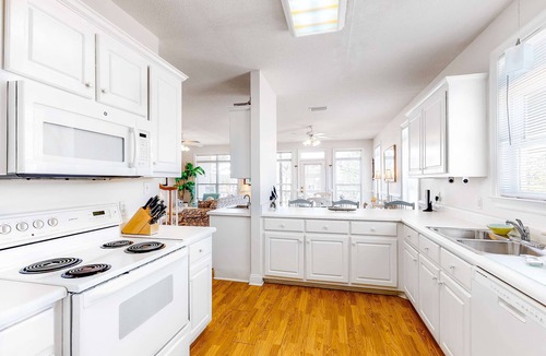 Audubon Place Condo | Bright duplex with two full kitchens, large decks, and private washer/dryers