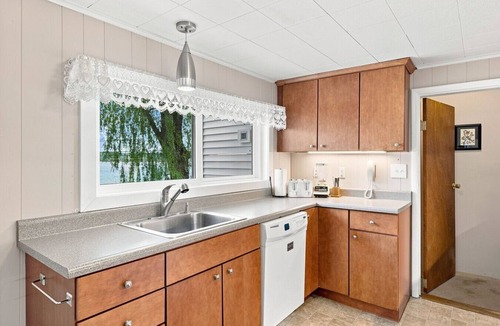 Beulah House | Classic Crystal Lake Cottage with Dock, Mooring Buoy, Fire Ring & Beach Area