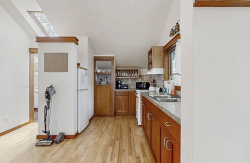Glen Arbor Cottage | Downtown cottage with nearby beach access, a grill, deck, & washer/dryer