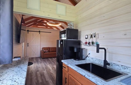 Tuscumbia Cabin | Enjoy cabin #65 at Heritage Acres Park with swimming, splash pad & more!