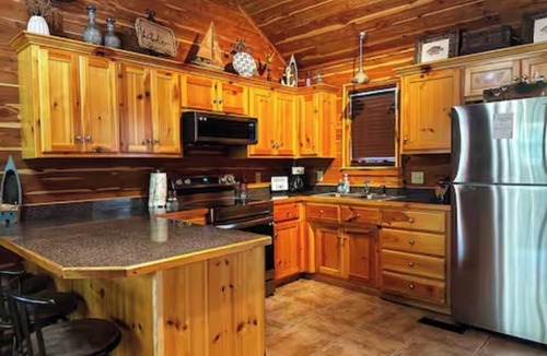 Mid America Cabin | Located directly on the water — private boat slip, boat ramp, and swim area.