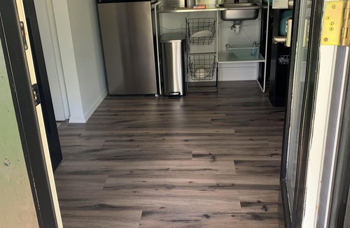 Eastman Cottage | Modern tiny house with large outdoor area and grill.