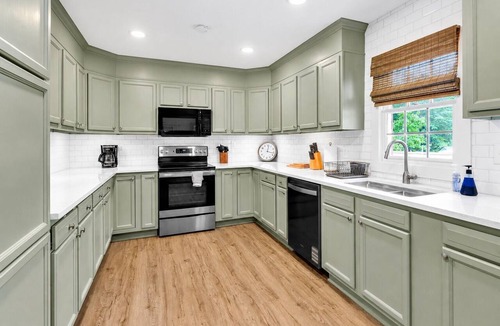 Jacksons' Gap House | Relax at this updated Lake Martin retreat with a private dock, spacious deck, firepit seating, covered patio, and bright open living spaces—perfect for lake days, family getaways, and Auburn weekends.