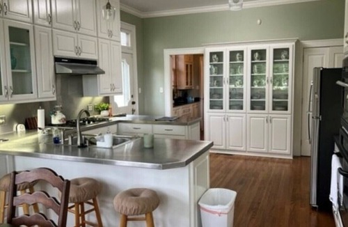 Magnolia House | Relax sitting on wrap around porch in this Historic Mansion