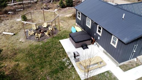 Idlewild House | Secluded Rustic Cabin with Hot Tub Near Pere Marquette River in Big Rapids, Michigan
