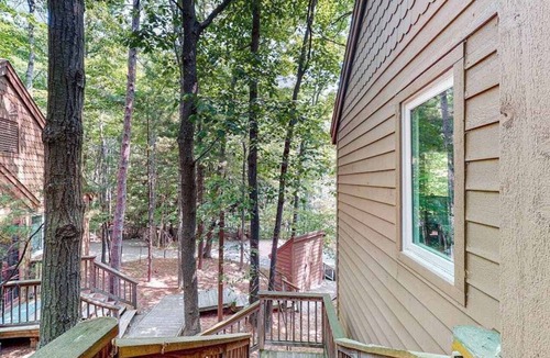 Maple City Condo | Upper-level condo with forest views, fireplace, soaking tub & high-speed WiFi