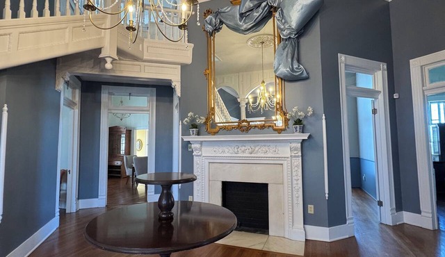 Relax sitting on wrap around porch in this Historic Mansion