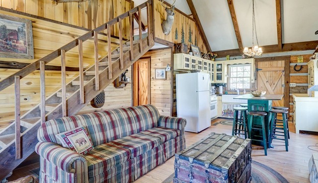 Rustic riverfront cabin with WiFi, a wraparound deck, & central AC