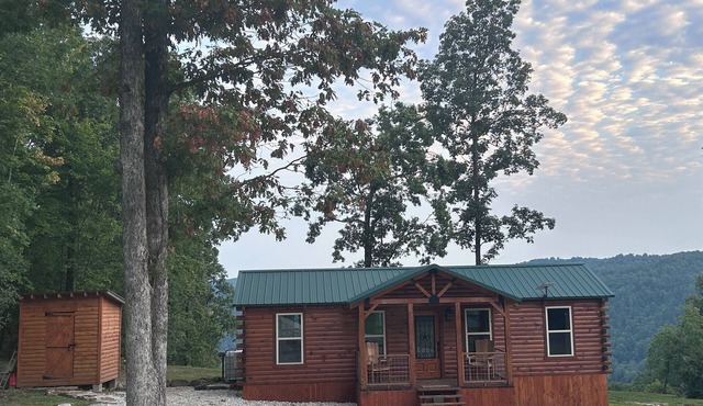 Secluded off grid cabin located on mountain ridge looking down beautiful valley